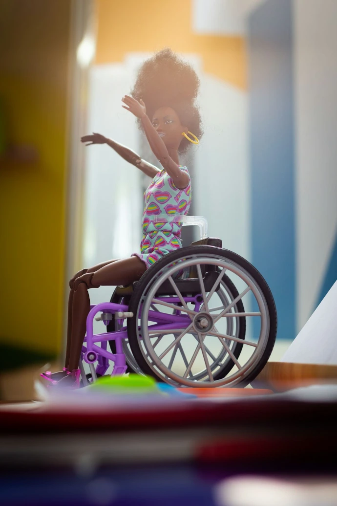 a doll is sitting in a wheel chair